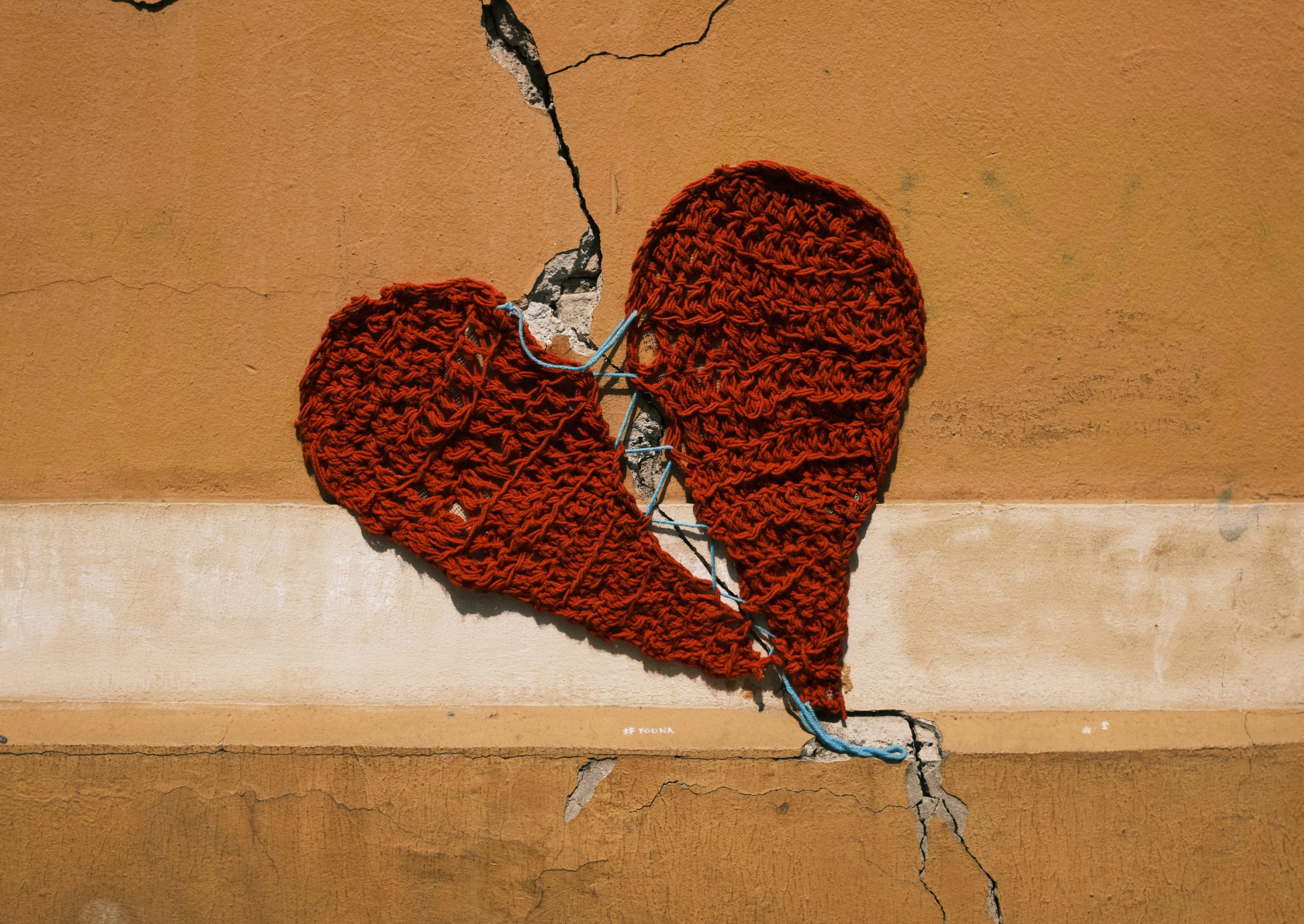 Stitched heart on plastered wall
