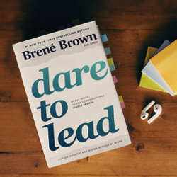 Dare to Lead book by Brené Brown on wood table.